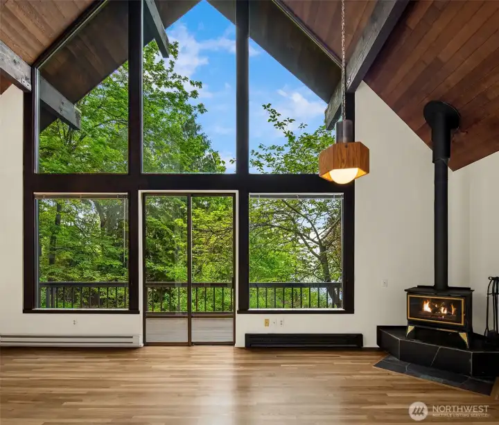 Incredible first impression with floor to high ceiling windows and dramatic cedar ceiling framing northwest greenery and everchanging skies.