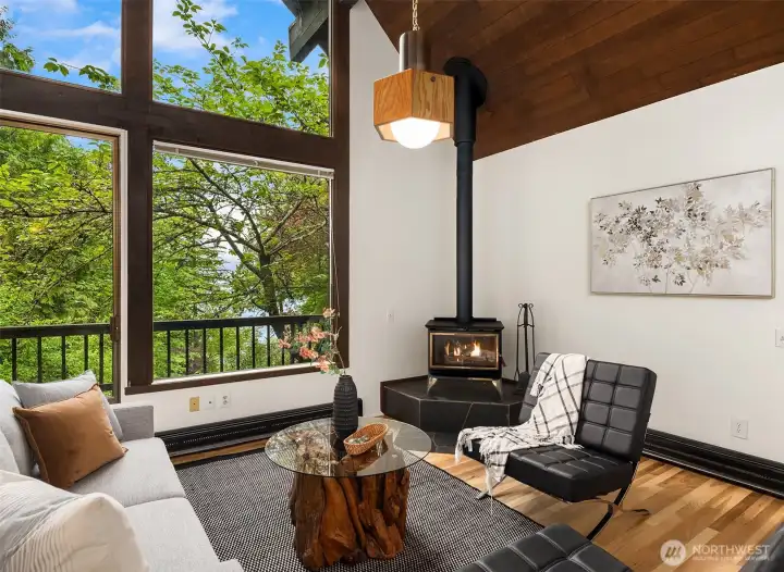 Living/dining area features fresh hardwood flooring and the extra romance of a wood stove.