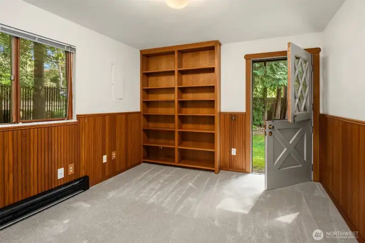 Main level office/bedroom with built-in bookcases and Dutch door to backyard.