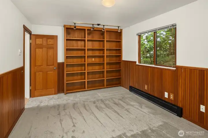 Main level office/bedroom with built-in bookcases. Door to hall.