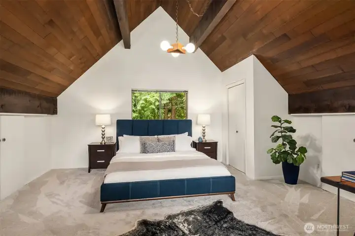 Exposed beams and rich warm cedar ceiling add to the northtwest aesthetic of this Island hideaway. Primary room includes a closet in addition to extra carpeted storage with sliders on both sides of room.