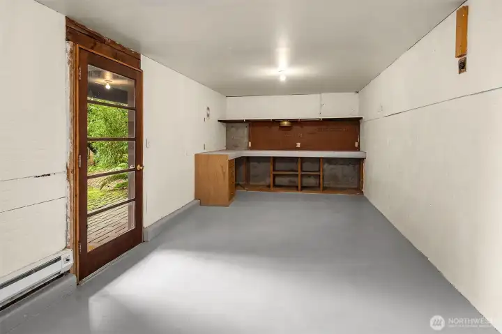 Down steps from the entry patio find the lower level finished and heated laundry/workshop/storage area.