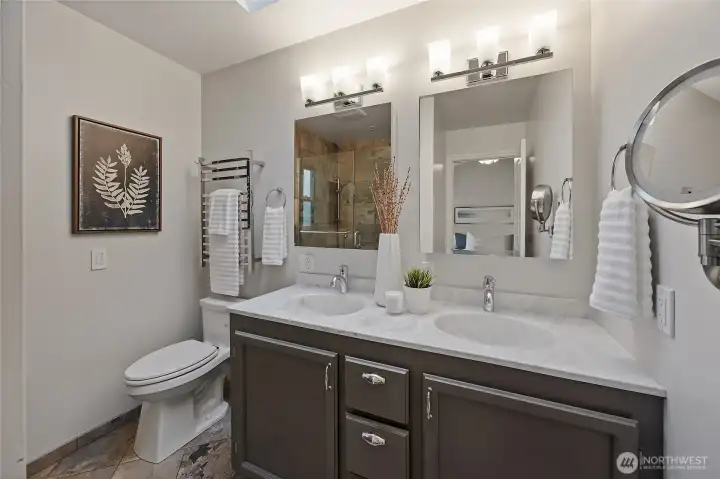 Primary bath with double sinks and radiant floor heat. Primary bath with double sinks and radiant floor heat.