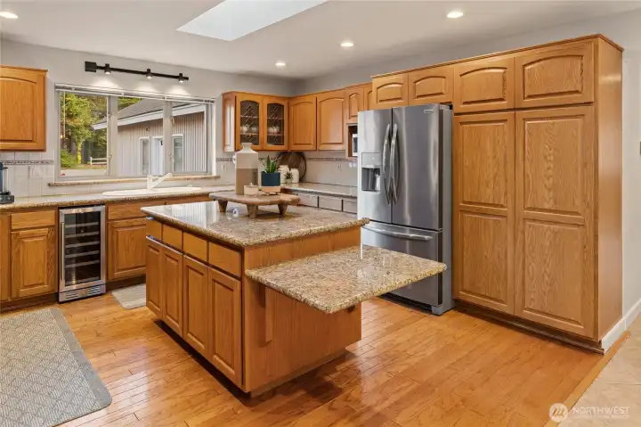 Another view of the kitchen, don't miss the convenient beverage fridge and large picture window over the sink.