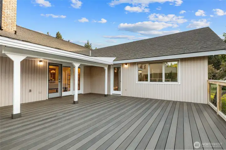 Newly rebuilt with low-maintenance Trex-style decking, this expansive deck is partially covered and ideal for outdoor relaxation and entertaining.