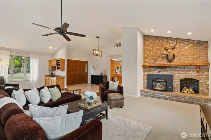 The thoughtful flow throughout this home creates an inviting atmosphere for everyday living and entertaining. The spacious living room features a striking brick fireplace that serves as a beautiful focal point, while the nearby wet bar adds convenience for hosting.