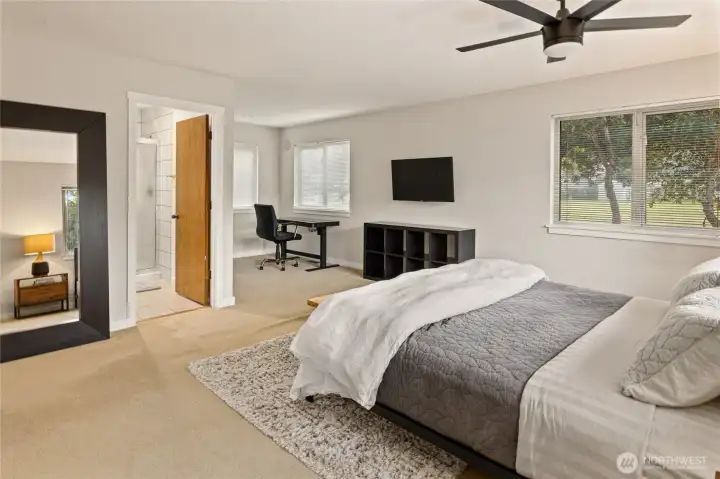 The spacious primary suite offers plenty of flexibility, with room for a desk, reading nook, or comfortable sitting area.