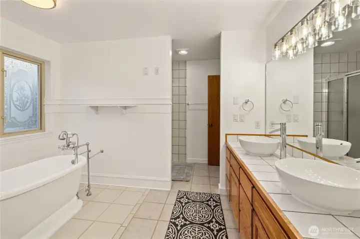 Retreat to the spectacular five-piece primary bath, complete with dual vanities, a soaking tub, and separate shower.