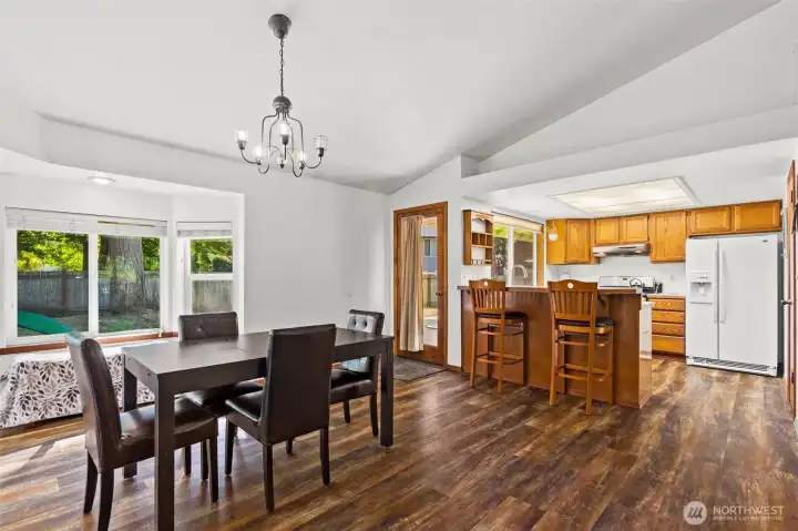 Dining and kitchen areas with access to backyard deck. Dining and kitchen areas with access to backyard deck.