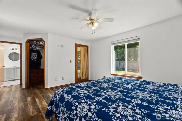 View of en suite, walk-in closet and door to access backyard deck. View of en suite, walk-in closet and door to access backyard deck.
