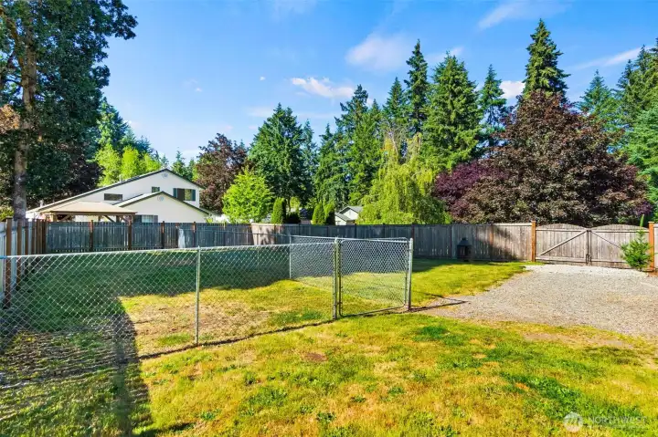 View of gate into backyard and fenced-off space. View of gate into backyard and fenced-off space.