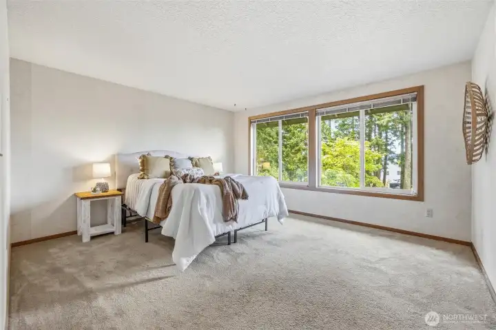 Spacious primary bedroom looking out to views. Spacious primary bedroom looking out to views.