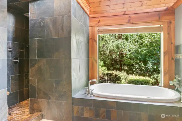 A jetted soaking tub overlooking the private greenbelt.