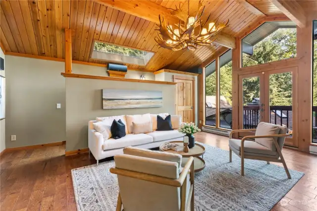 Vaulted ceilings, a family room with surround sound, a wet bar kitchen space, and a private deck with stunning mountain views creating a serene oasis for relaxation.