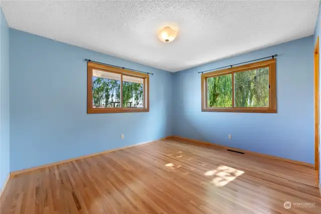 Primary bedroom with gorgeous wood floors.