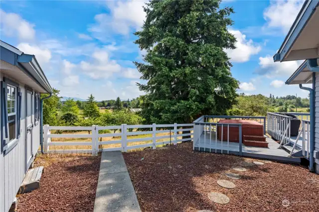 To the left is the large storage shed. The gate leads to the orchard. Hot Tub is included in the sale