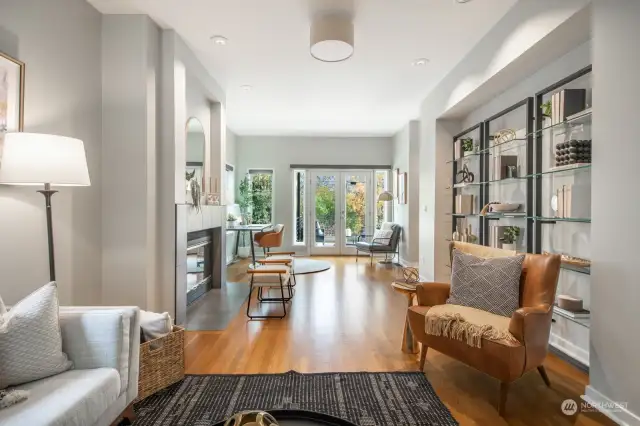 The living room is filled with natural light and offers several seating areas.