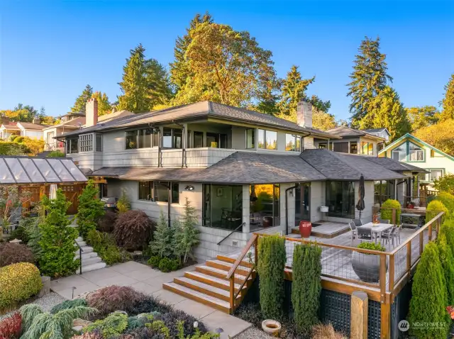 All day sun with the southern exposure. Covered patio on the left. Large entertainment deck on the right. Primary bedroom covered balcony in the center. Rooftop deck visible above right.