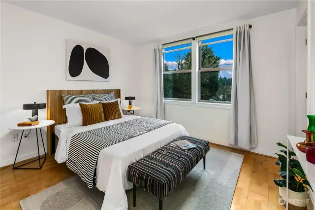 Two bedrooms with oversized windows and walk in closets are ideally positioned on opposite corners of the home for privacy —the owner’s suite with en suite bath and a second bedroom plus additional full bath.