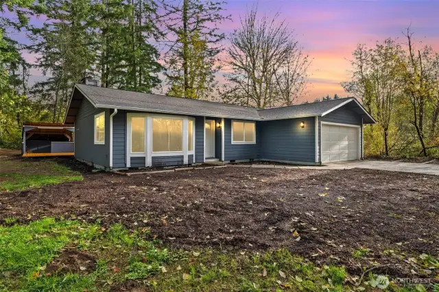 The exterior of the home has undergone a stunning transformation. With new exterior paint, a new garage door, stylish light fixtures, and fresh landscaping—including forestry mulching to clear the property of small trees and undergrowth, along with topsoil and bark—this home enhances both curb appeal and functionality. The newly paved driveway adds to the property's style and durability, making it a true oasis.