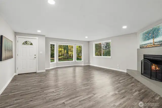 The fireplace imparts a sense of coziness, warmth, and positive energy. The open, airy, and easy flow of this family room is ideal for both daily living and entertainment. Canned lighting adds bright, non-glaring light, enhancing the overall ambiance. Luxury Vinyl Plank flooring adds beauty. Ample windows allow just the right amount of light into each room, enhancing the soothing ambiance created by the fresh interior paint colors, which complement any decor and infuse the home with warmth and positive energy....