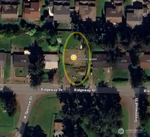 Newer homes behind and neighborhood natural space across the street