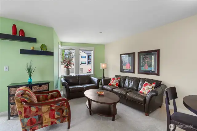 Living Room enjoys excellent natural light and easy access to Dining space and kitchen.