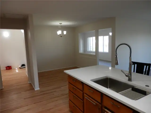 Entry is to the left which comes into the kitchen, dining room and family room areas.