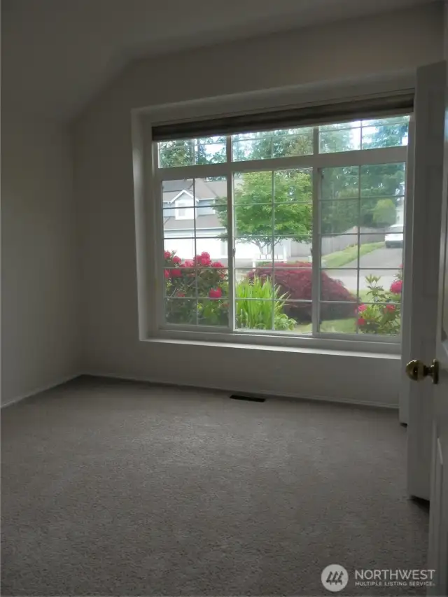 This bedroom looks to the west and the front yard area.