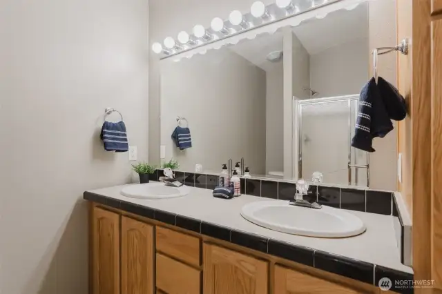 Simple and functional, with everything you need to get ready for the day or wind down at night—just steps from the primary bedroom.