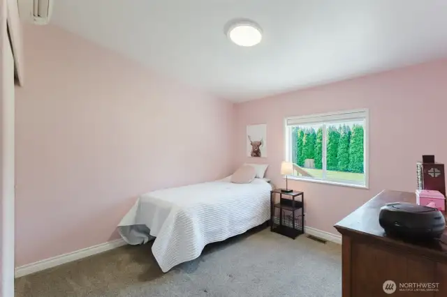 Bright and comfortable, this bedroom works well for guests, kids, or a cozy creative space.
