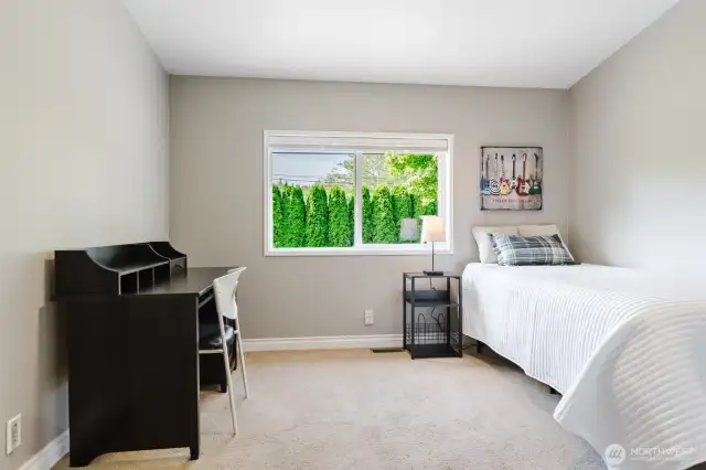 Filled with natural light, this third bedroom is ready to fit your needs—whether it's for family, guests, or a hobby room.
