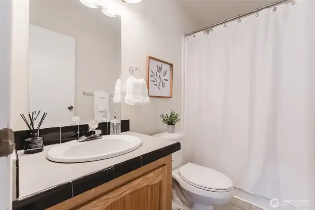 Fresh and functional—this main bathroom is easily accessible from the common areas and secondary bedrooms.