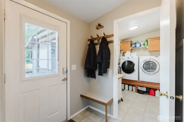 Conveniently tucked near the back entrance, this laundry room offers storage, counter space, and a quiet spot to tackle daily tasks—washer and dryer included!