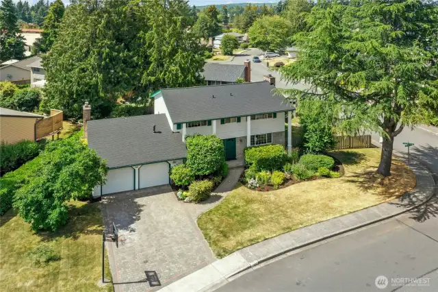 With your corner location, your gorgeous driveway, and your brick and clapboard exterior, your home makes a dramatic impression. The brand new roof helps with that, as well!