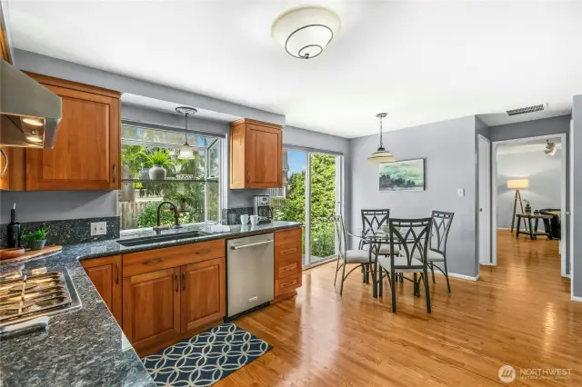 Granite counters, gas cooking, and comfortable hardwood floors all make cooking here a breeze.