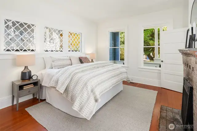 Generous main floor bedroom with period fireplace.