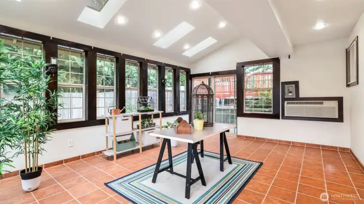 A versatile sunroom filled with natural light—ideal as a lounge, creative studio, or indoor garden.