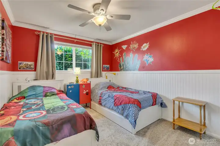 Cheerful bedroom with wainscoting detail and new carpet.
