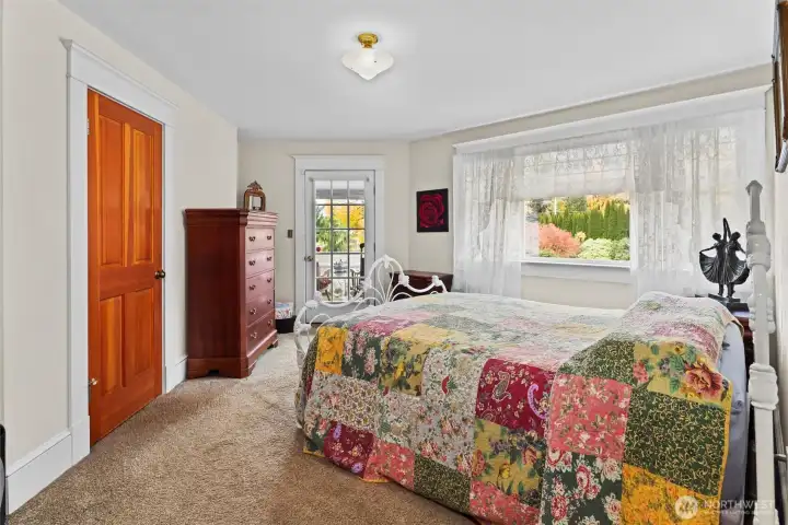 Primary bedroom with door to covered sitting area.