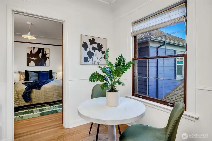 Large window in dining space lets in breakfast light.