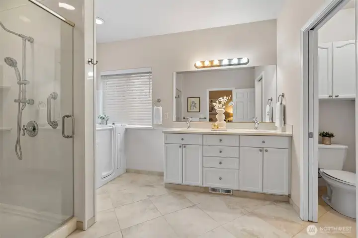 A tru spa-like bathroom with dual sinks, huge shower and walk-in tub