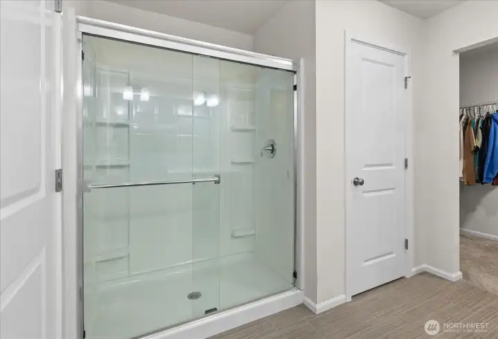 Primary full bath with peak of the walk-in closet.