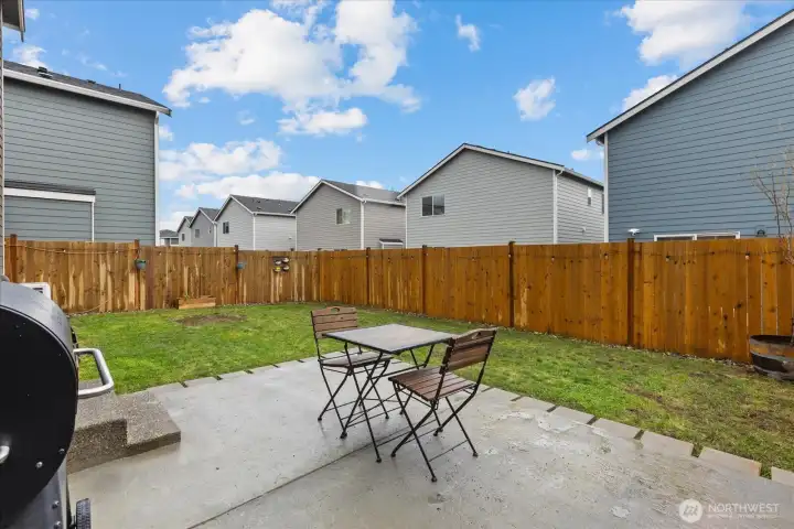 Backyard featuring new fencing and patio.