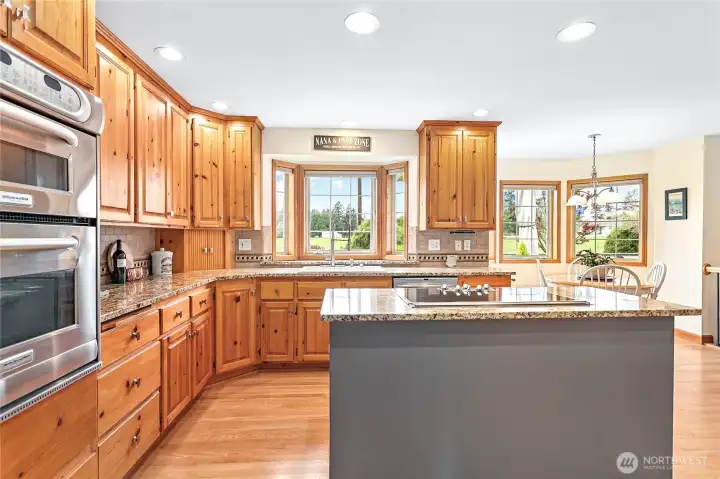 Ample storage throughout kitchen w/solid hickory cabinets, granite counters, full height tile backsplash & stainless steel appliances