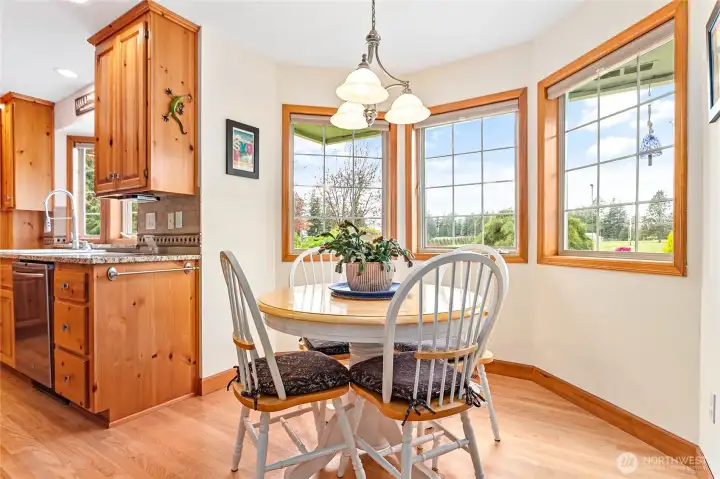 Cozy breakfast nook bump out just off kitchen with expansive view of backyard & beyond