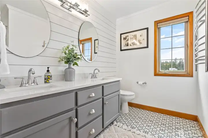 Full size bathroom upstairs also remodeled in 2021 with tile flooring, quartz countertops, dual vanity, lovely shiplap wall. Includes tub/shower & large linen closet