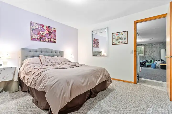 And one more time, through this room, huge heated and carpeted space currently used for storage w/access to stairwell leading to garage & outside