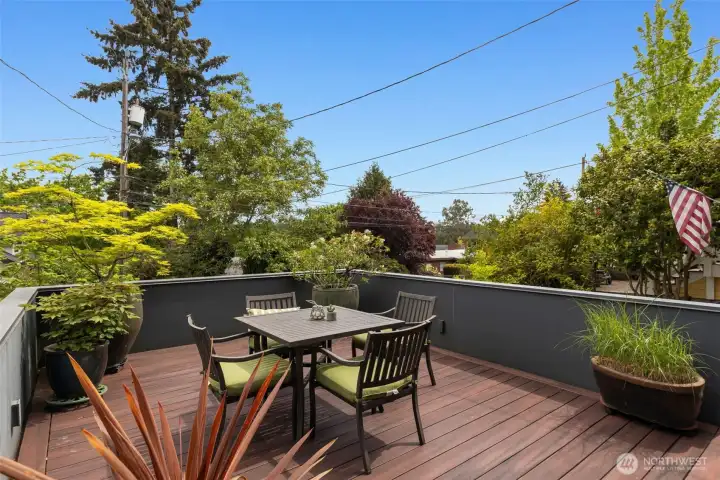 The generous front deck feels like a private retreat, elevated above the street and bathed in morning light - an ideal setting for a quiet cup of coffee and the morning paper