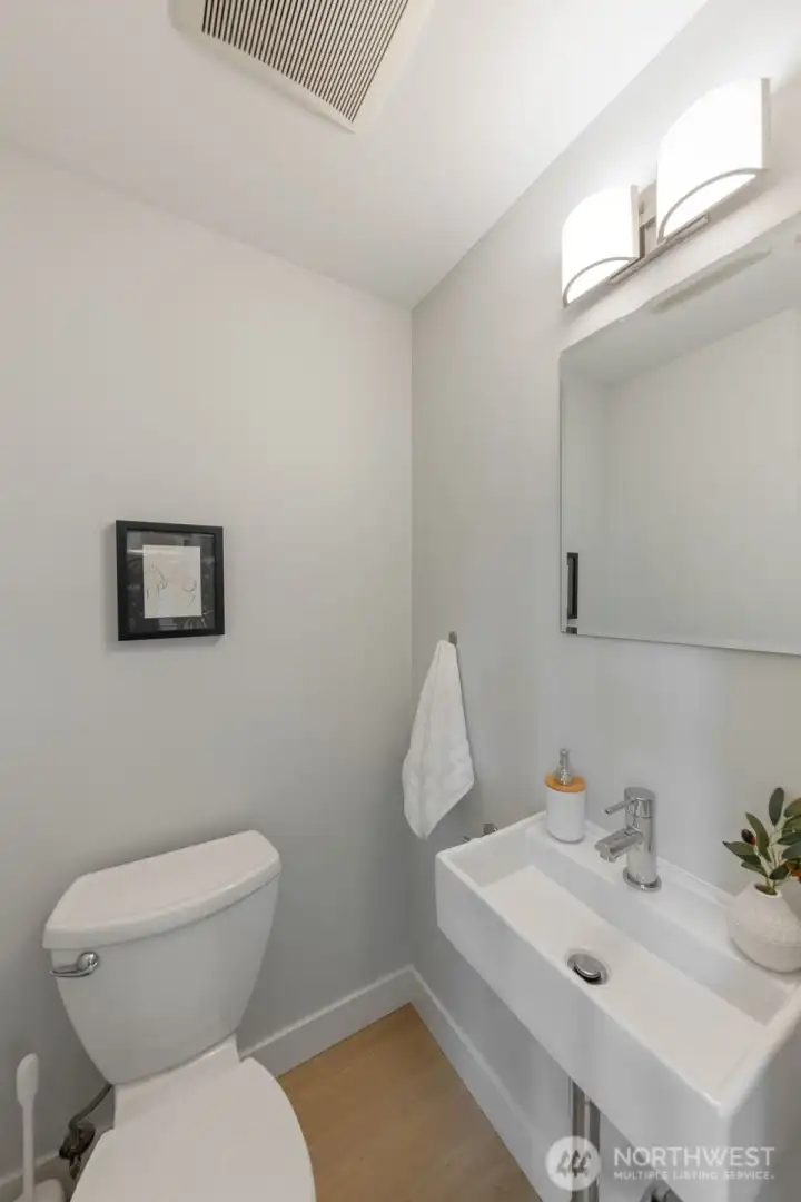 Main floor powder room with recently updated lighting and pedastal sink